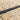 Metallic cable on a gravel surface