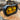 Black and yellow off-road light on a wooden log with 'GG Lighting' branding.