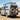 Van with off-road modifications on a dirt road